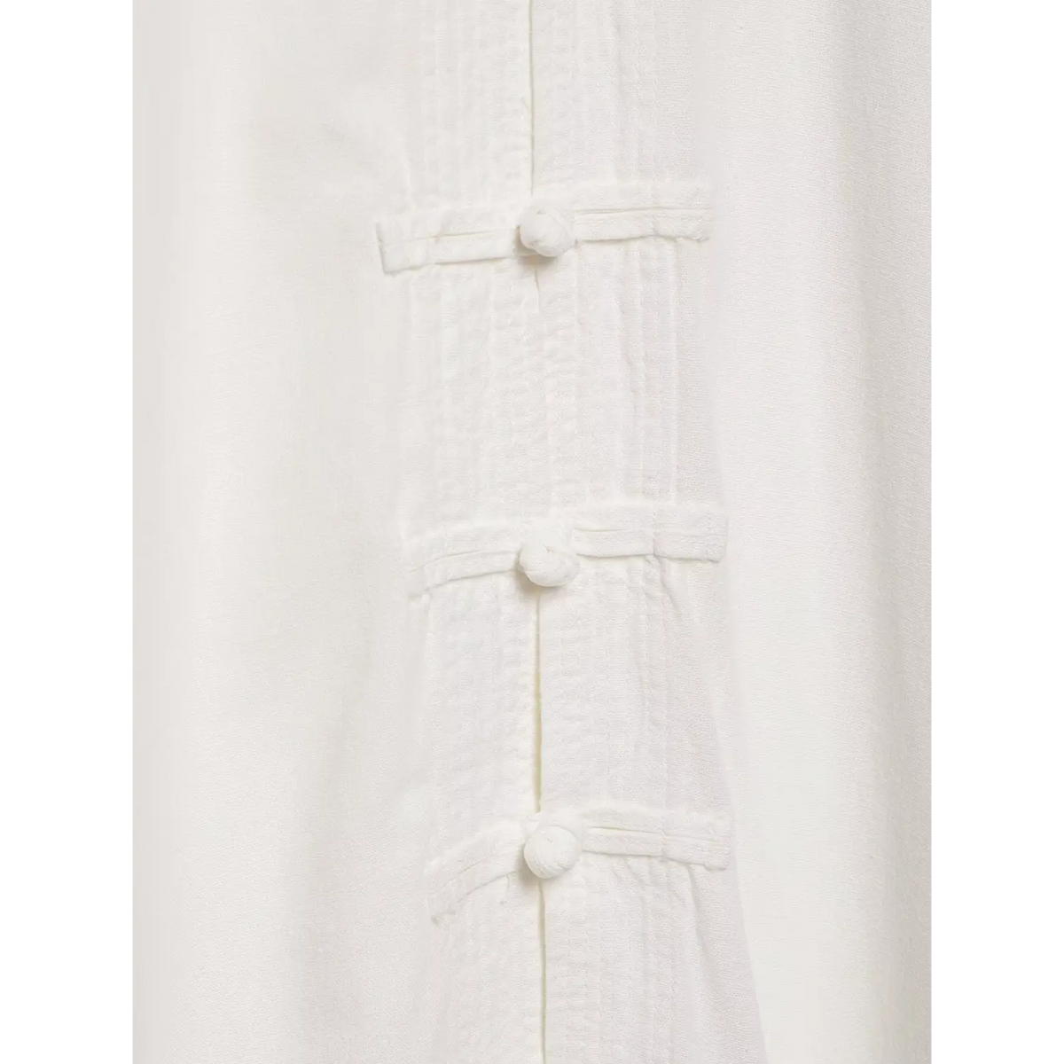 Close-up of vertical stripe placket and frog buttons