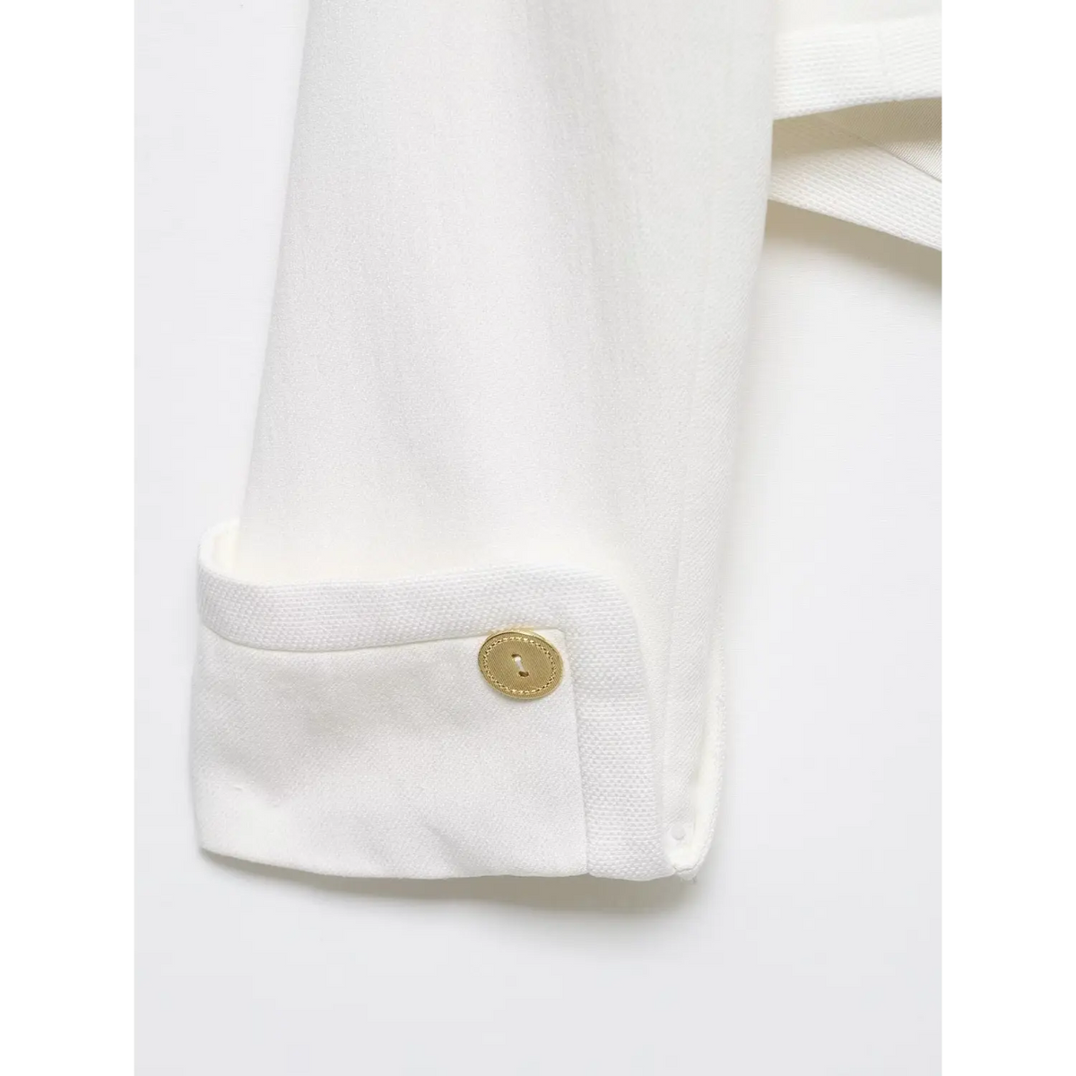 Close-up of folded cuff gold button