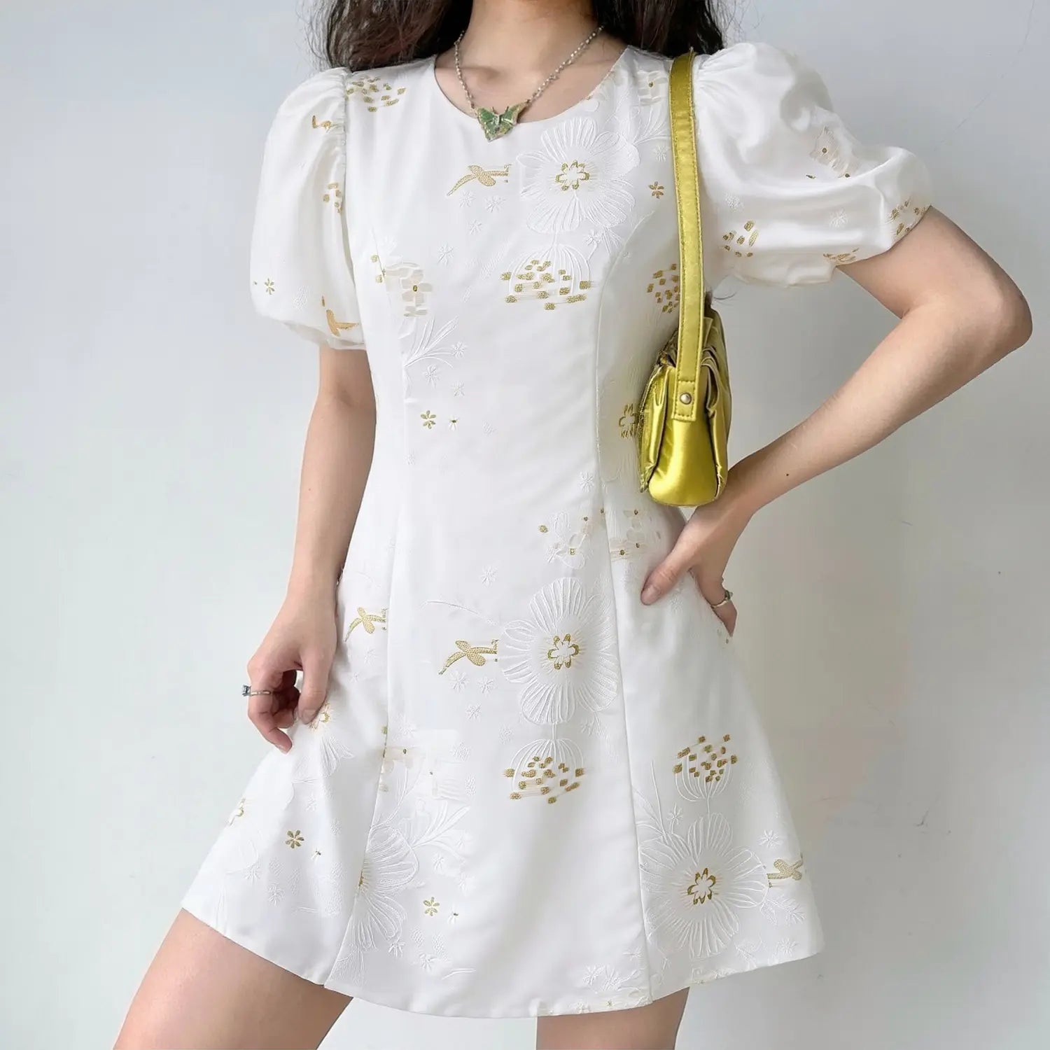 Model full body shot of white satin mini dress with golden floral & bird jacquard embroidery, round neck puff sleeve slim A-line short new chinese style dress