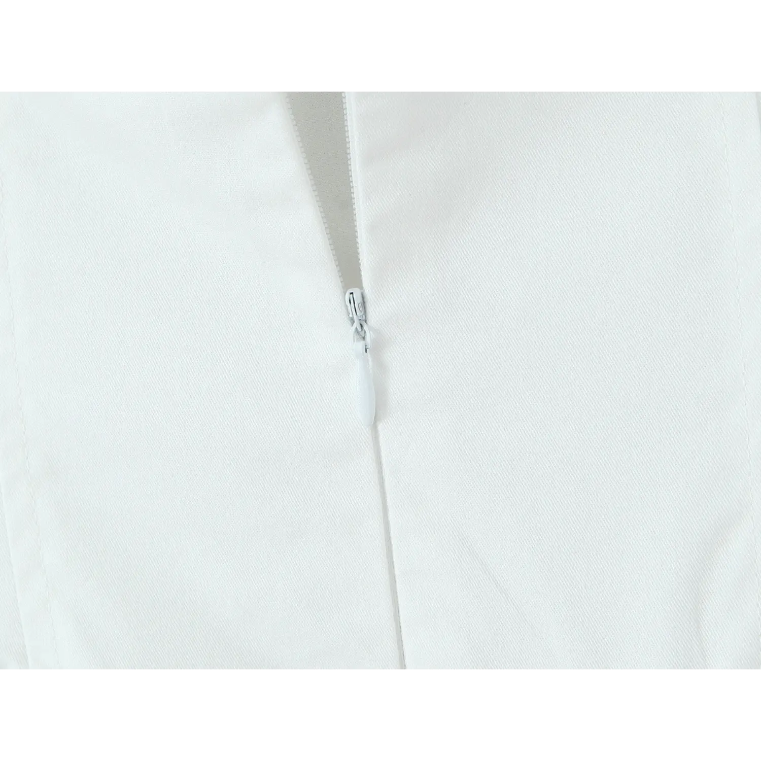 Back closeup, invisible covered zipper on white embroidered halter mini dress
