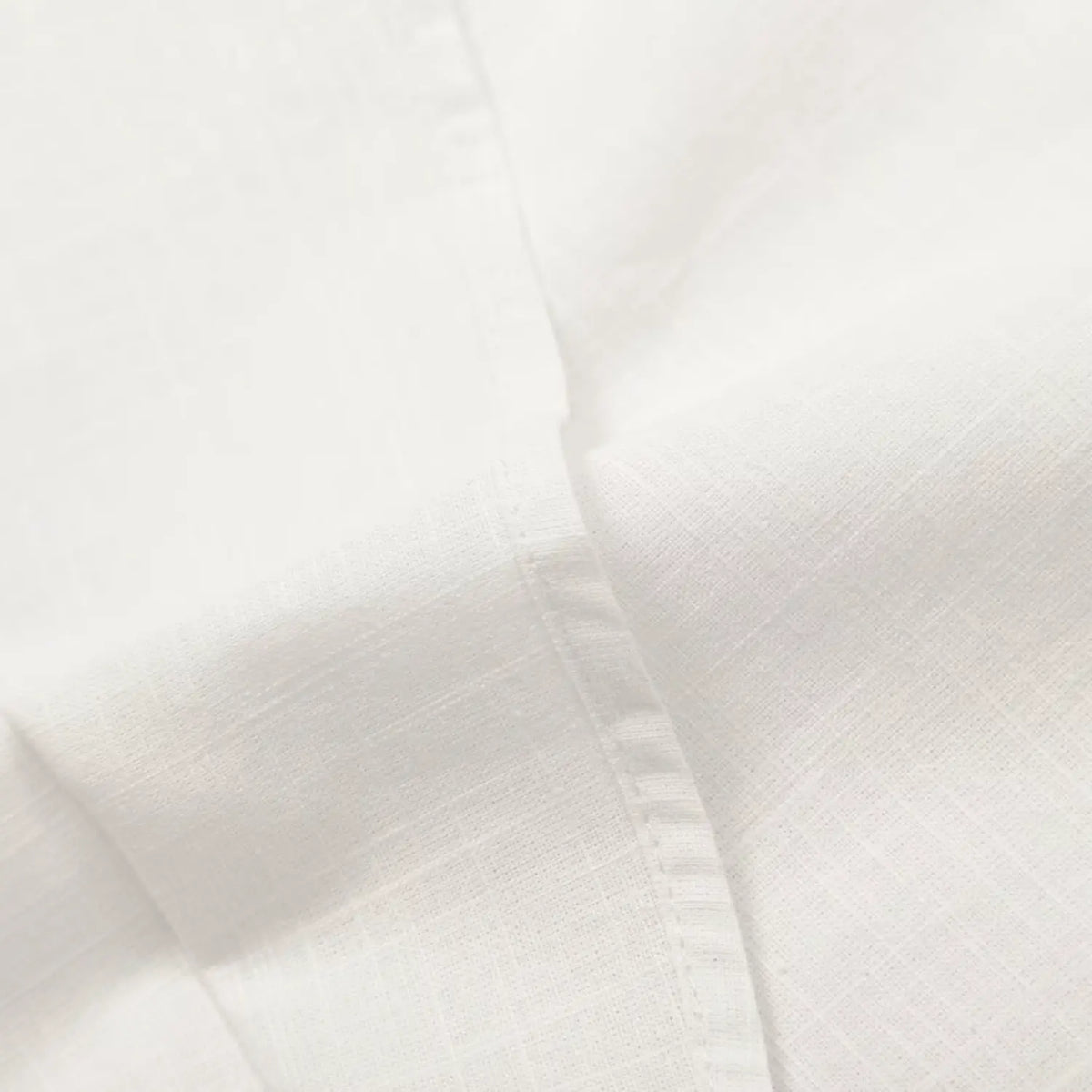 Close-up of finished side seam on white skirt fabric