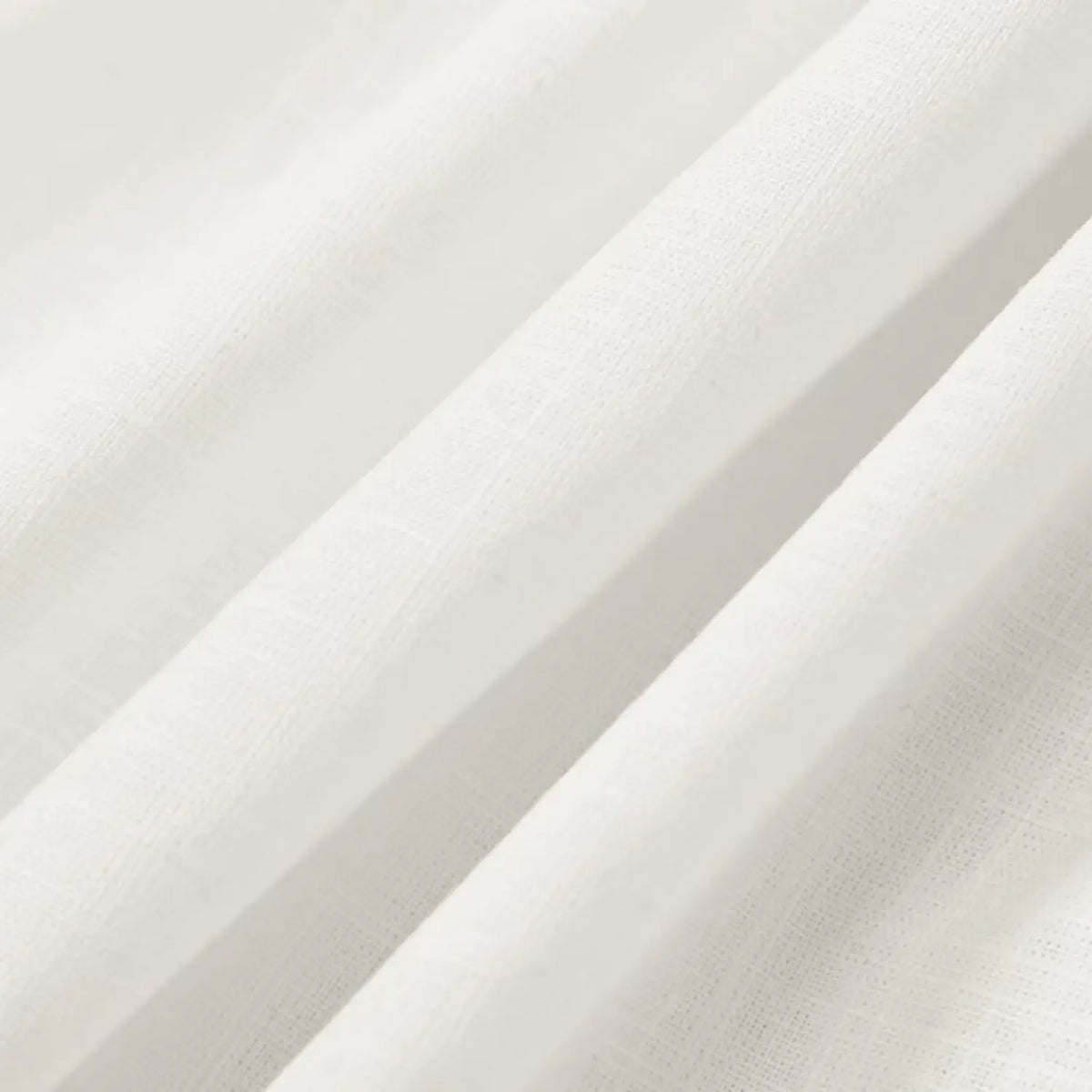 Close-up of lightweight white skirt fabric with soft folds