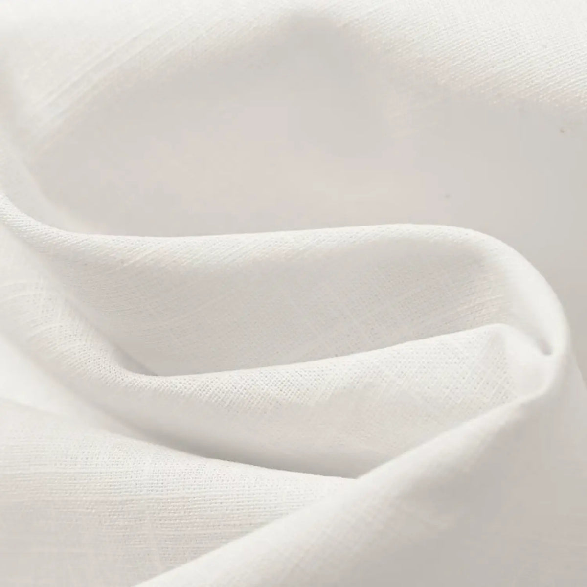 Close-up of draped white skirt fabric texture
