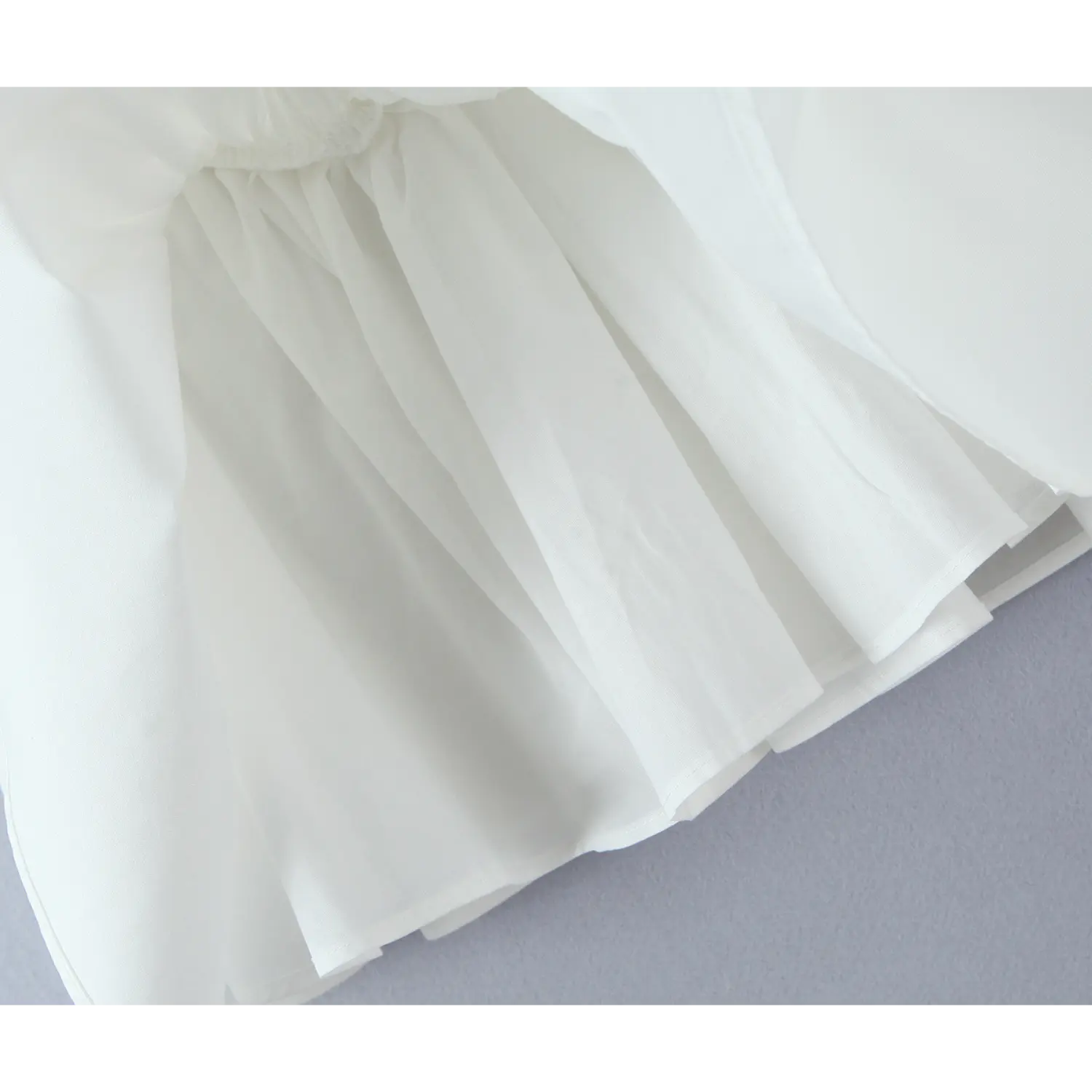 Closeup skirt lining shot, lightweight inner lining under flowy white flared skirt