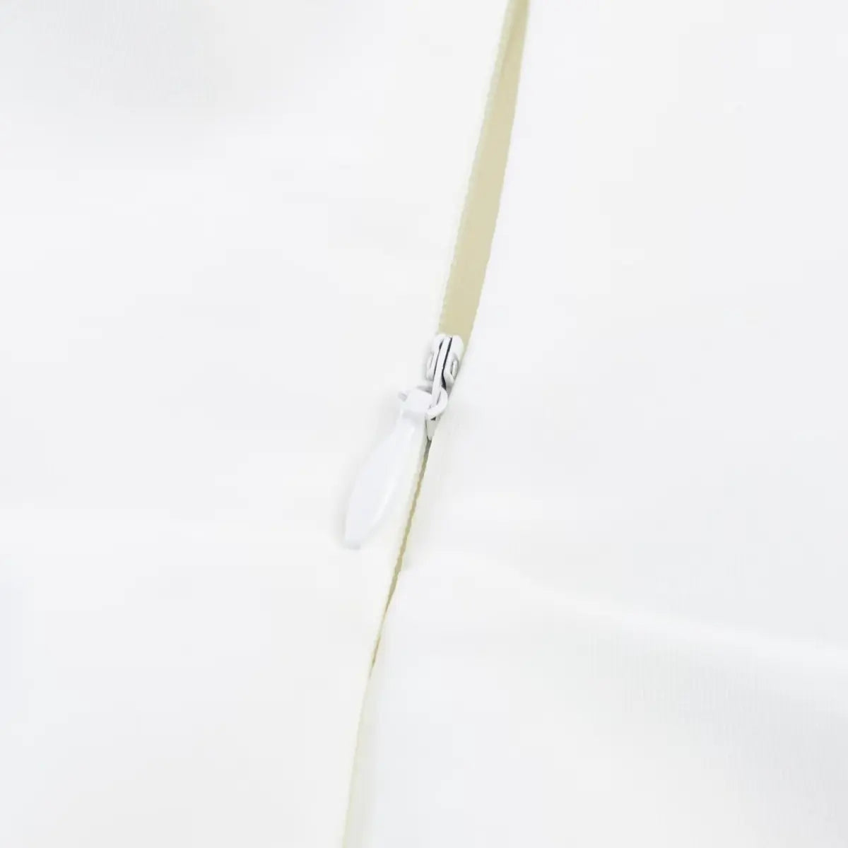  Close-up of the back zipper on white halter dress, showing smooth closure and neat fabric finish.