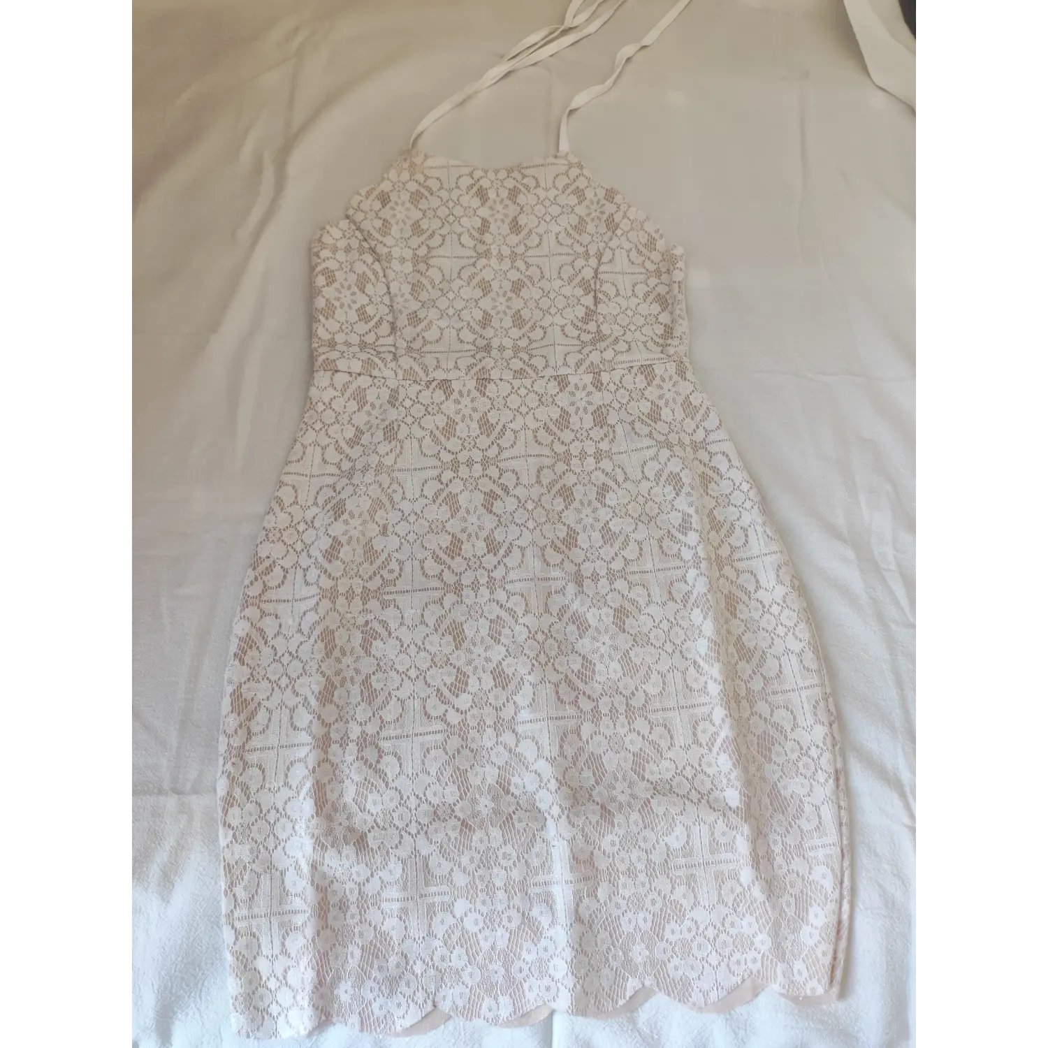 Flat lay front view, white floral lace halter strap bodycon mini dress with nude lining