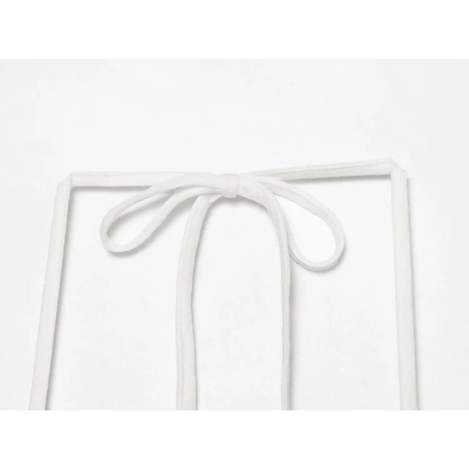 Back halter neck strap macro close-up, thin matching fabric tie knotted bow detail