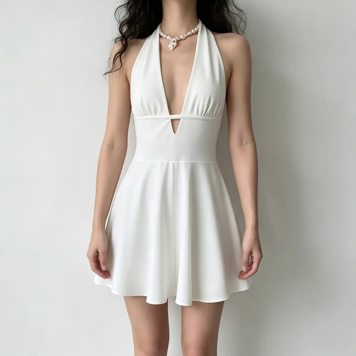 Model wearing a white halter mini dress with a deep V-neck, front keyhole cutout, and a flared skirt.