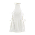 Front flat lay white halter sleeveless mini dress with side lace-up tie details on white background