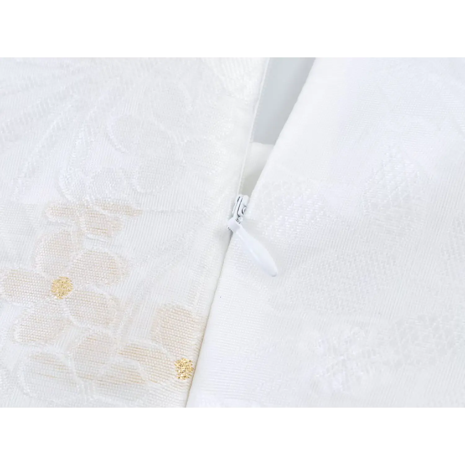 Back invisible zipper macro close-up, smooth white plastic pull tab, fine jacquard weave fabric surrounding zipper seam