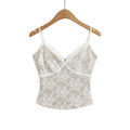 White lace cami top with V-neck, hanging on wooden hanger, front view