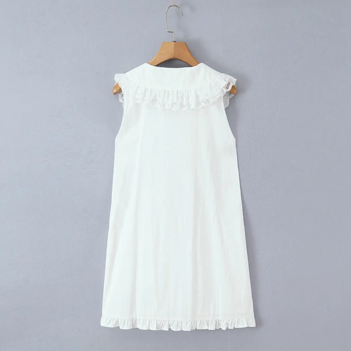 Hanging back view of the dress, showcasing the ruffled lace collar and simple back design.