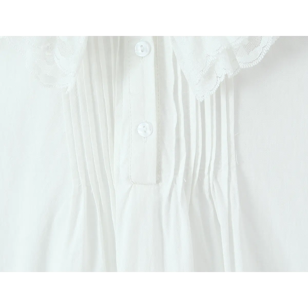  Close-up of the front placket, featuring mother-of-pearl buttons and pintuck pleats.