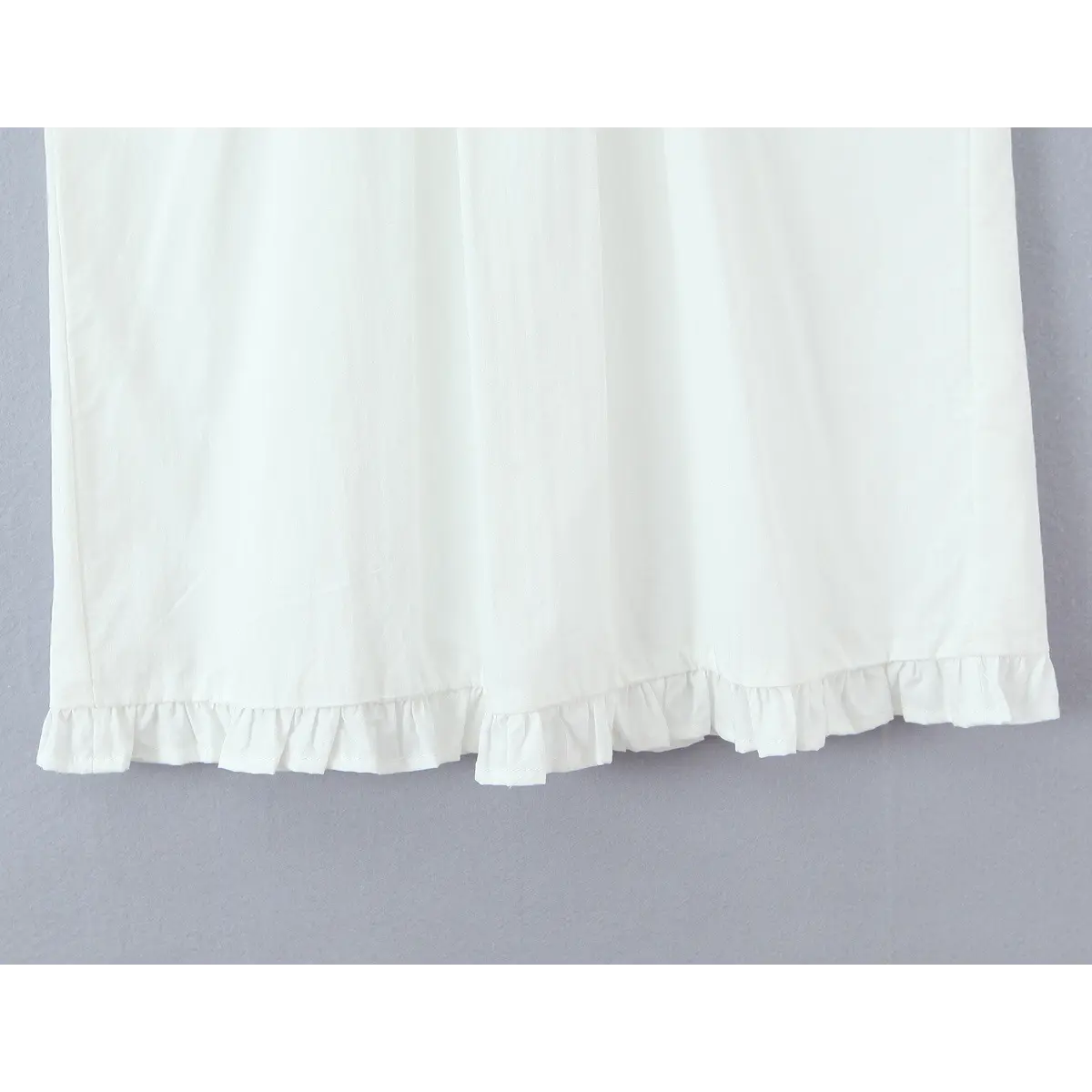 Close-up of the ruffled skirt hem, showing the gathered edge and clean stitching.