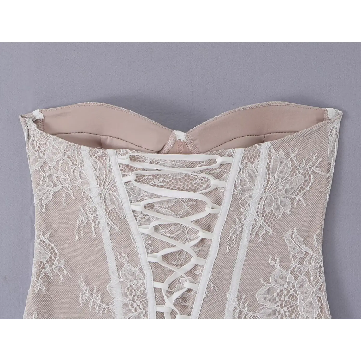 Close‑up inner view of strapless bust lining and back corset lacing structure
