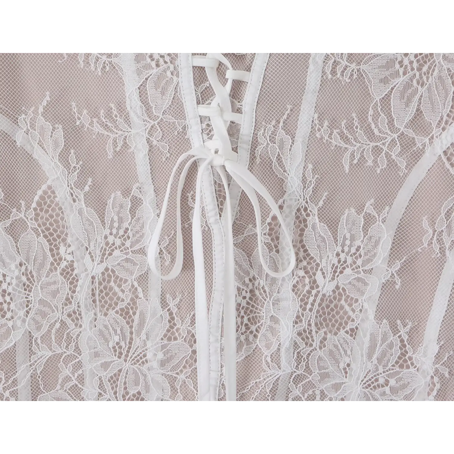 Close‑up of back corset lace‑up tie knot and fabric strap detail