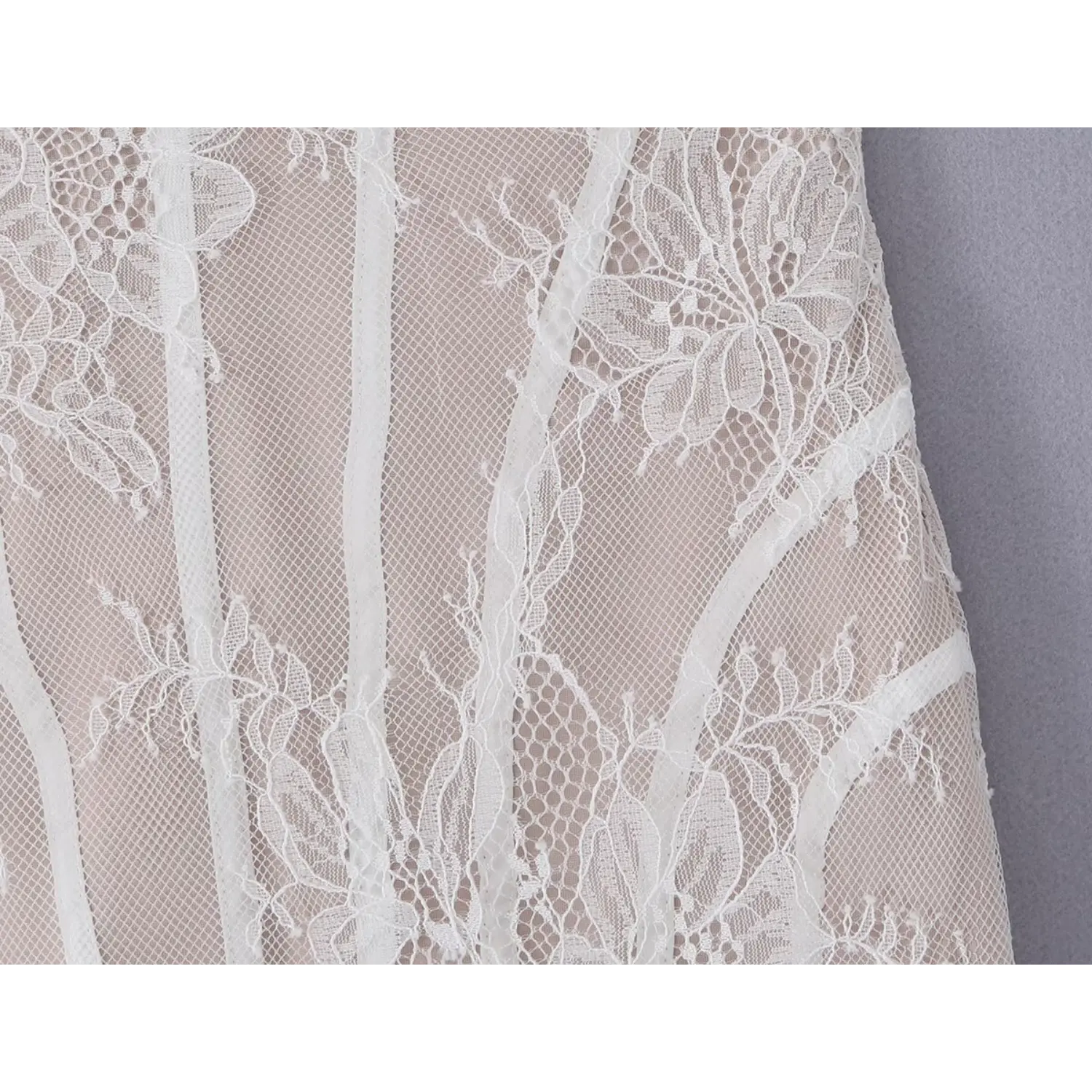 Close‑up view of body boning seams and floral lace mesh fabric texture