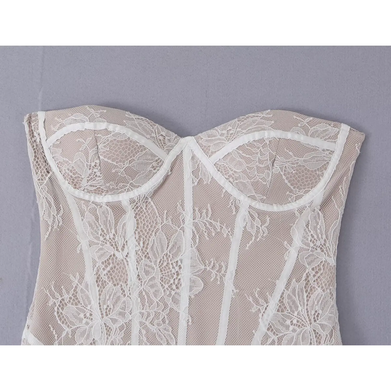 Flat lay front shot white floral lace strapless corset mini dress on grey background