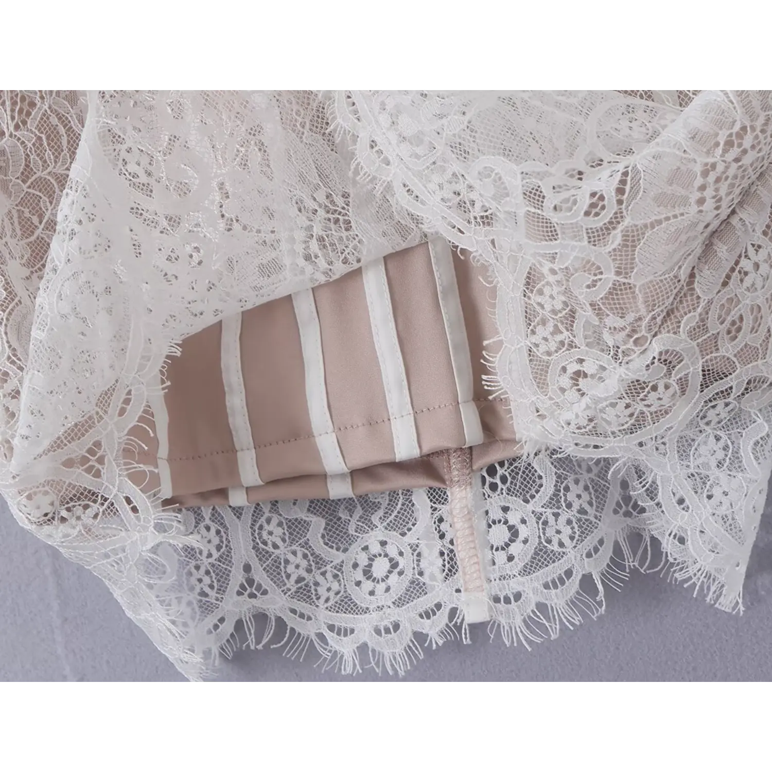 Close‑up shot of inner boning construction under lace overlay fabric