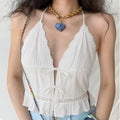 Front lifestyle shot on model, deep V floral scalloped lace halter cami, double front self tie bows, waist hollow lace & ruffle hem, sweet casual summer outfit