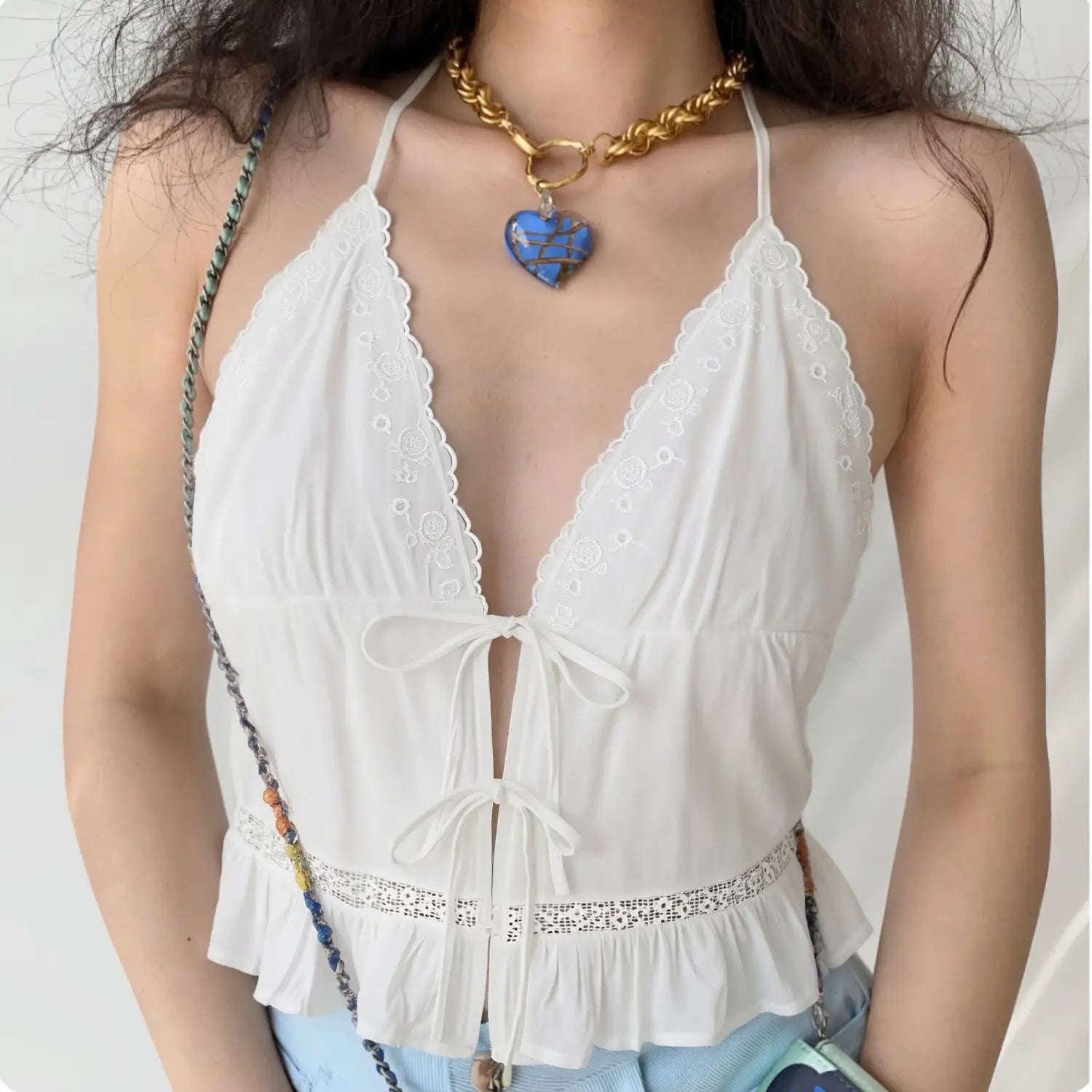 Front lifestyle shot on model, deep V floral scalloped lace halter cami, double front self tie bows, waist hollow lace & ruffle hem, sweet casual summer outfit