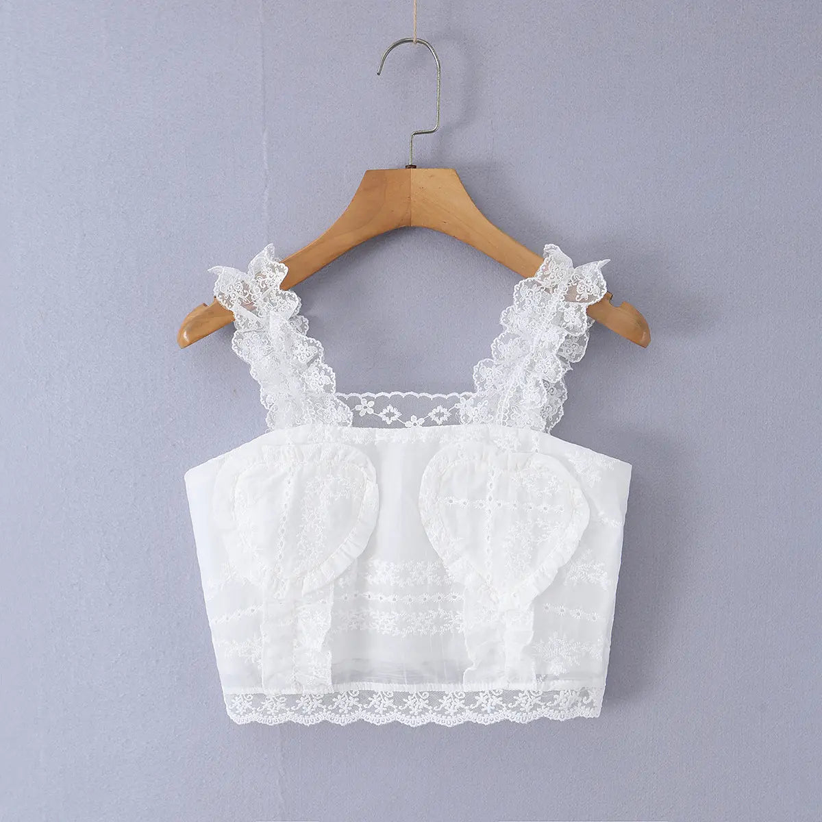 Full front view of the cropped cami top, featuring ruffled lace straps and heart-shaped embroidered bust details.