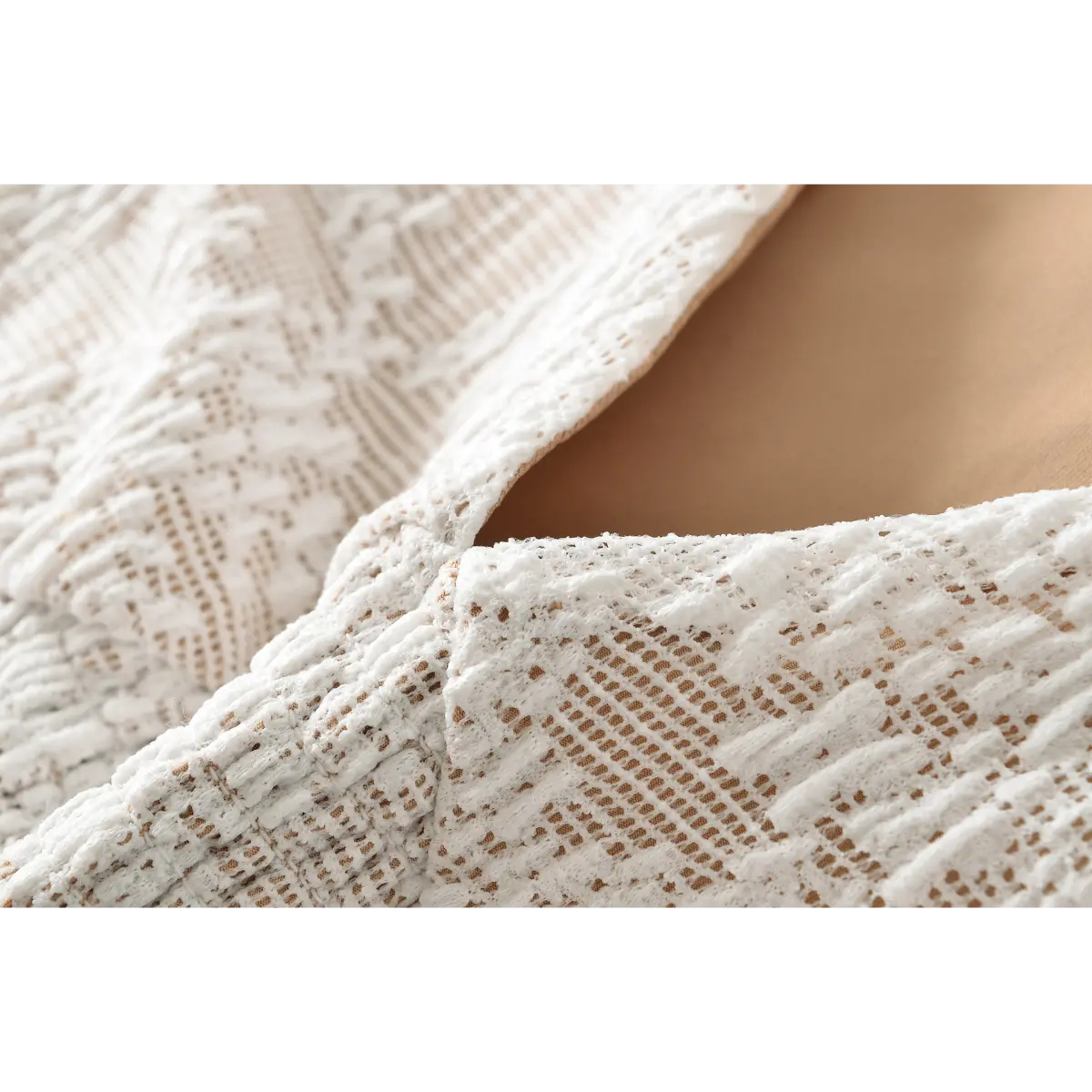 Close-up of the deep V-neckline and nude inner lining on the white lace top