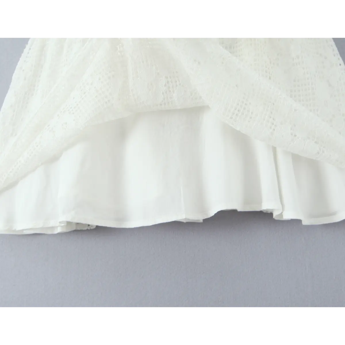 Close-up of the soft inner lining visible beneath the lace skirt hem