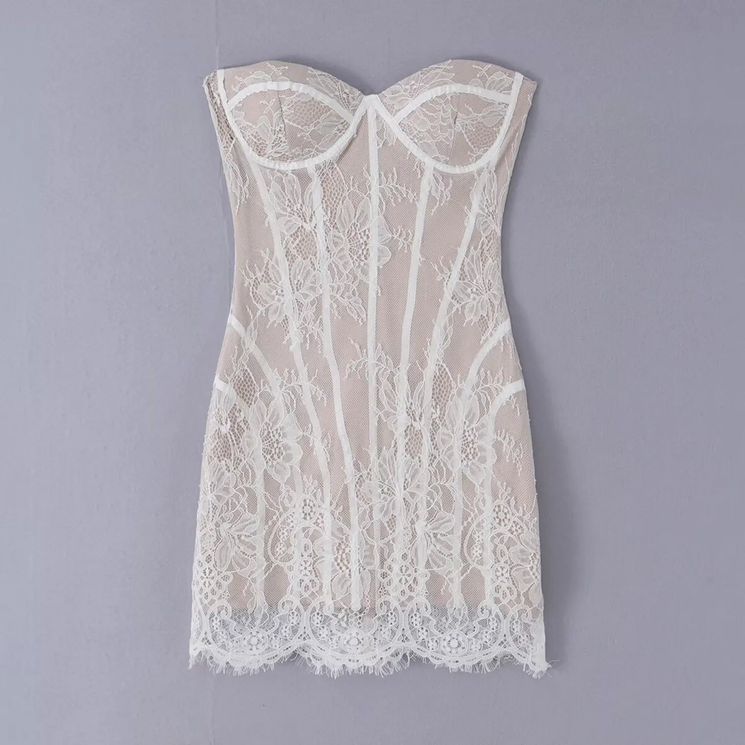 Flat lay front shot white floral lace strapless corset mini dress on grey background