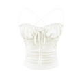Studio shot of white lace-trim cami top, featuring drawstring bust, lace trim and side ruching.