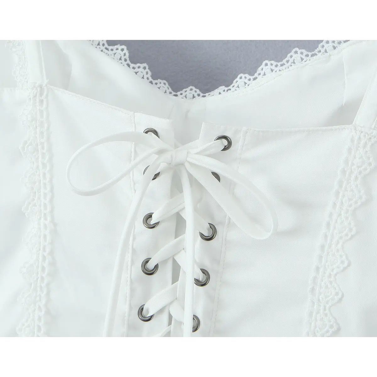Close-up of the corset-style lace-up closure on the back of the white dress