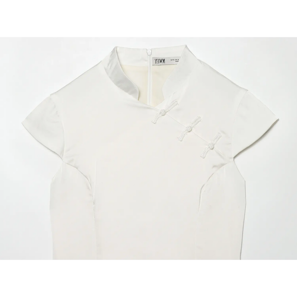 Close-up of mandarin collar and diagonal placket frog buttons