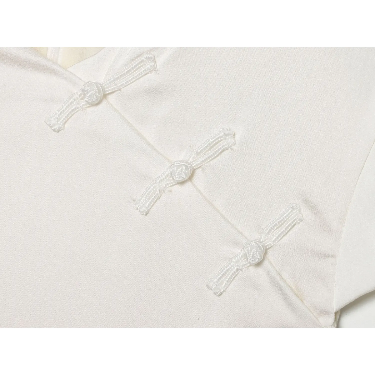 Close-up of diagonal placket frog buttons
