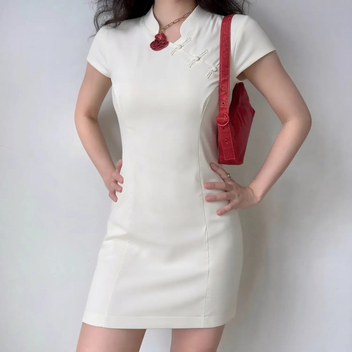 Model wearing white mandarin collar frog button short sleeve mini dress