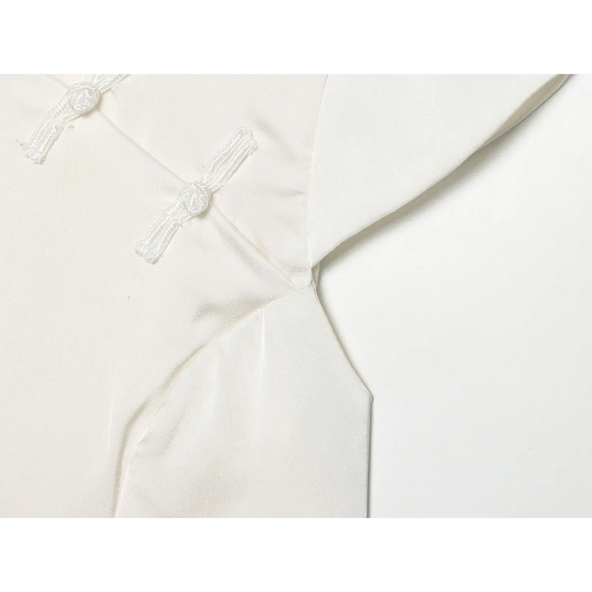 Close-up of frog button and armhole