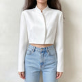 Model wearing white mandarin collar wrap front cropped jacket with jeans, front view