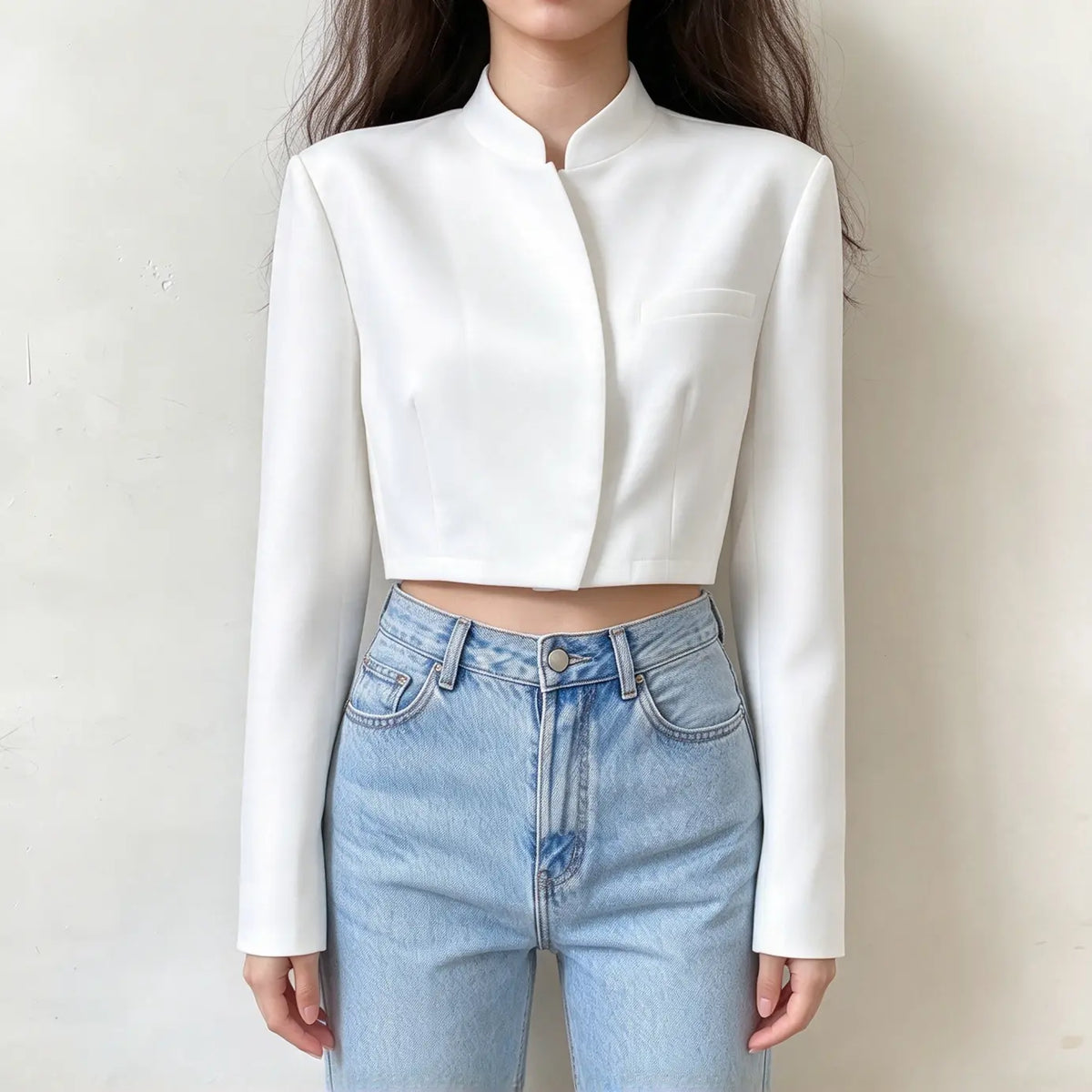 Model wearing white mandarin collar wrap front cropped jacket with jeans, front view