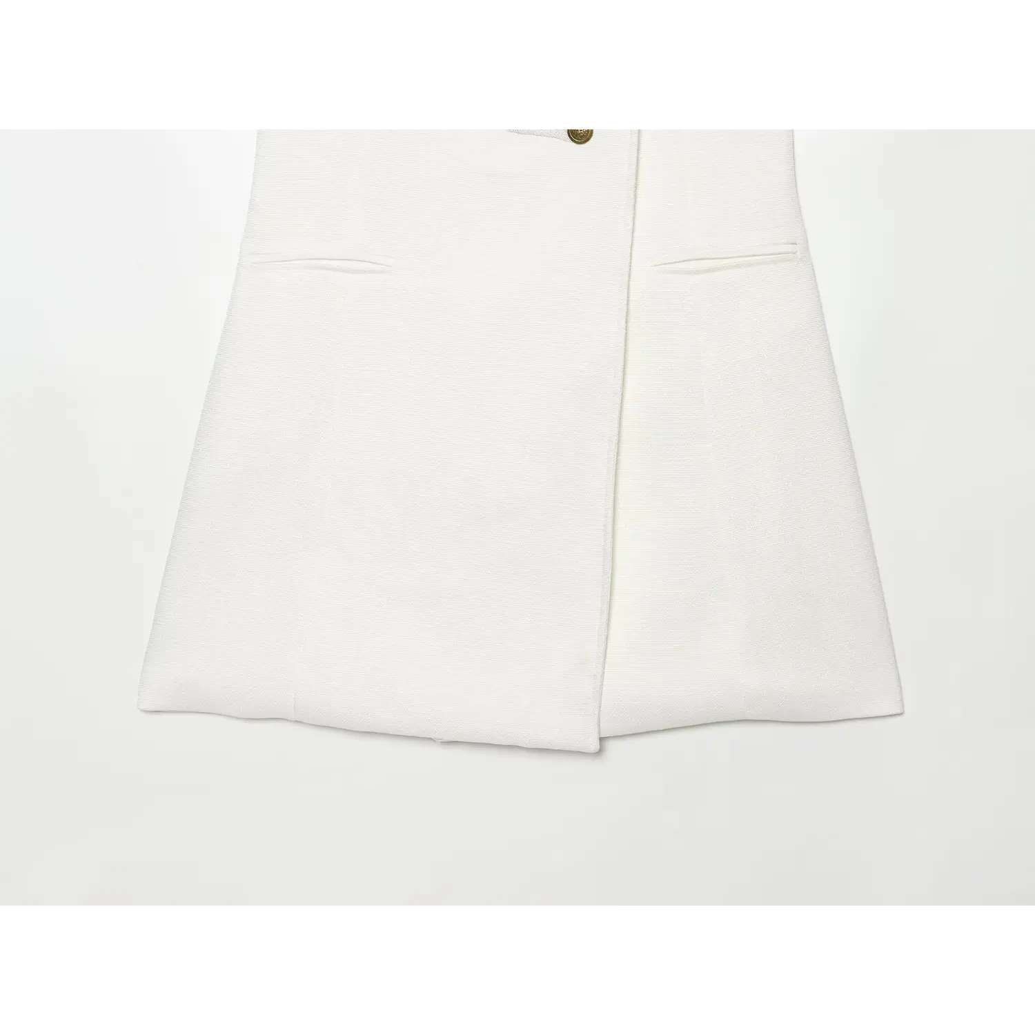 Close‑up of skirt hem, slit and front pocket details for white sleeveless military mini dress