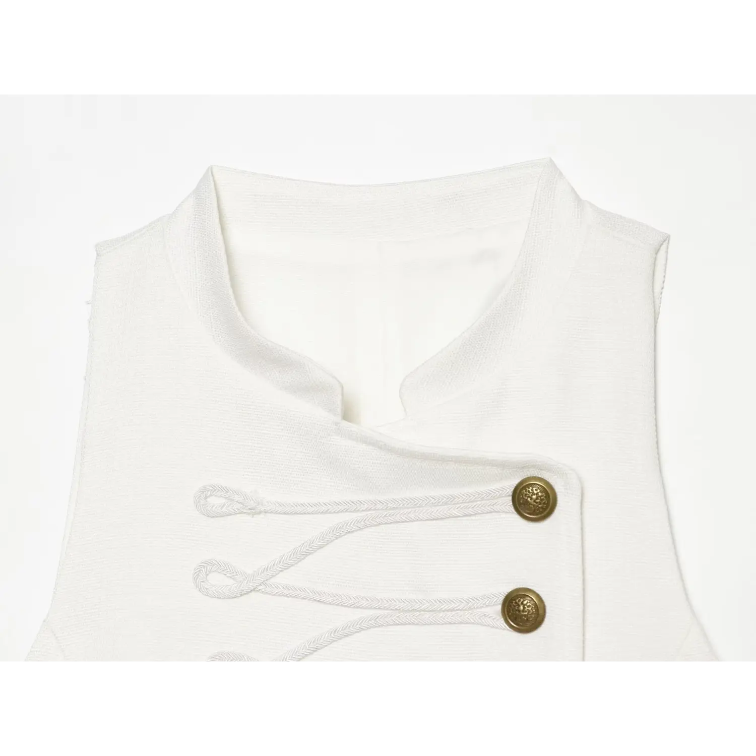 Close‑up view of stand collar, woven fabric texture and top gold button detail on white mini dress