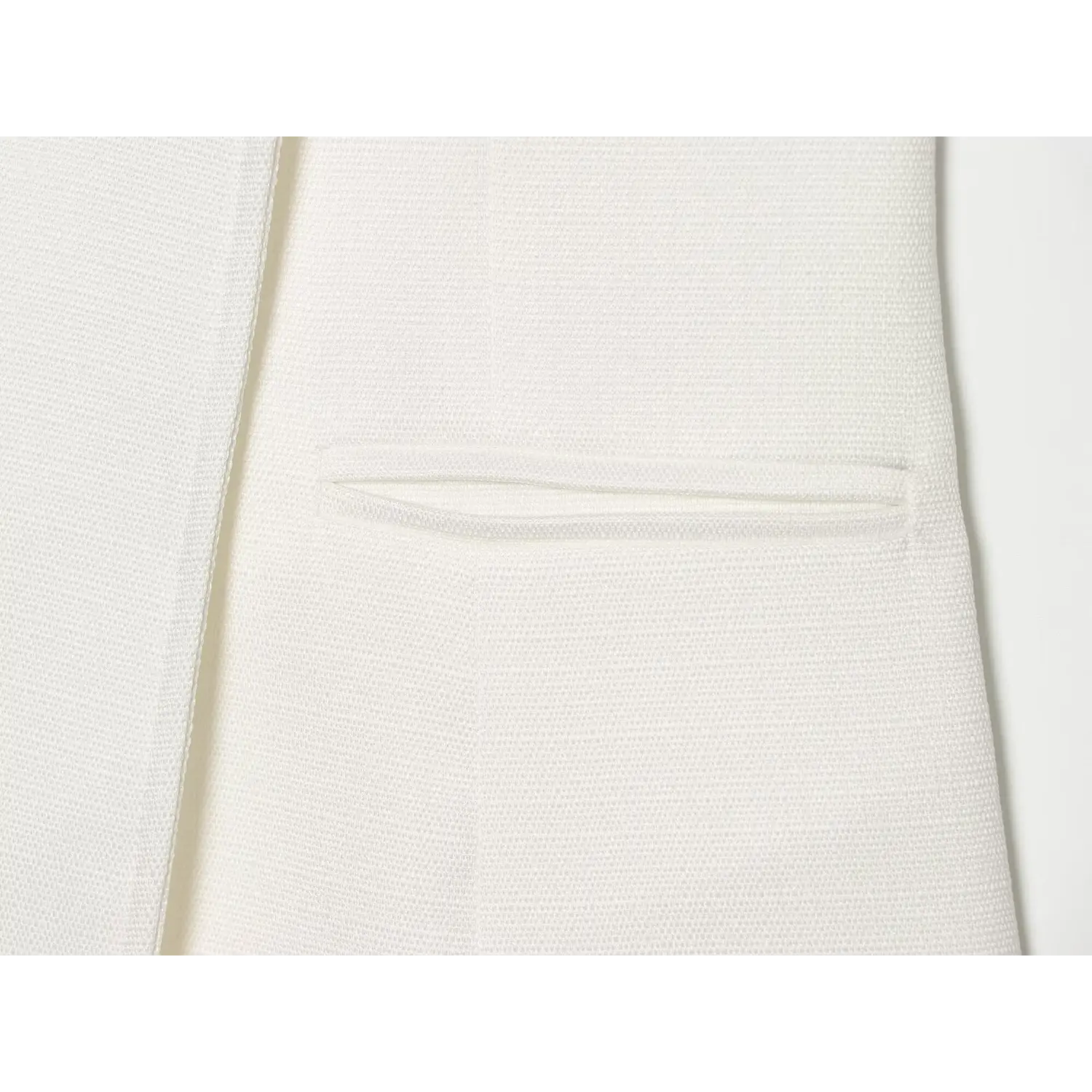 Close‑up shot of front slit pocket detail on white military‑style sleeveless mini dress