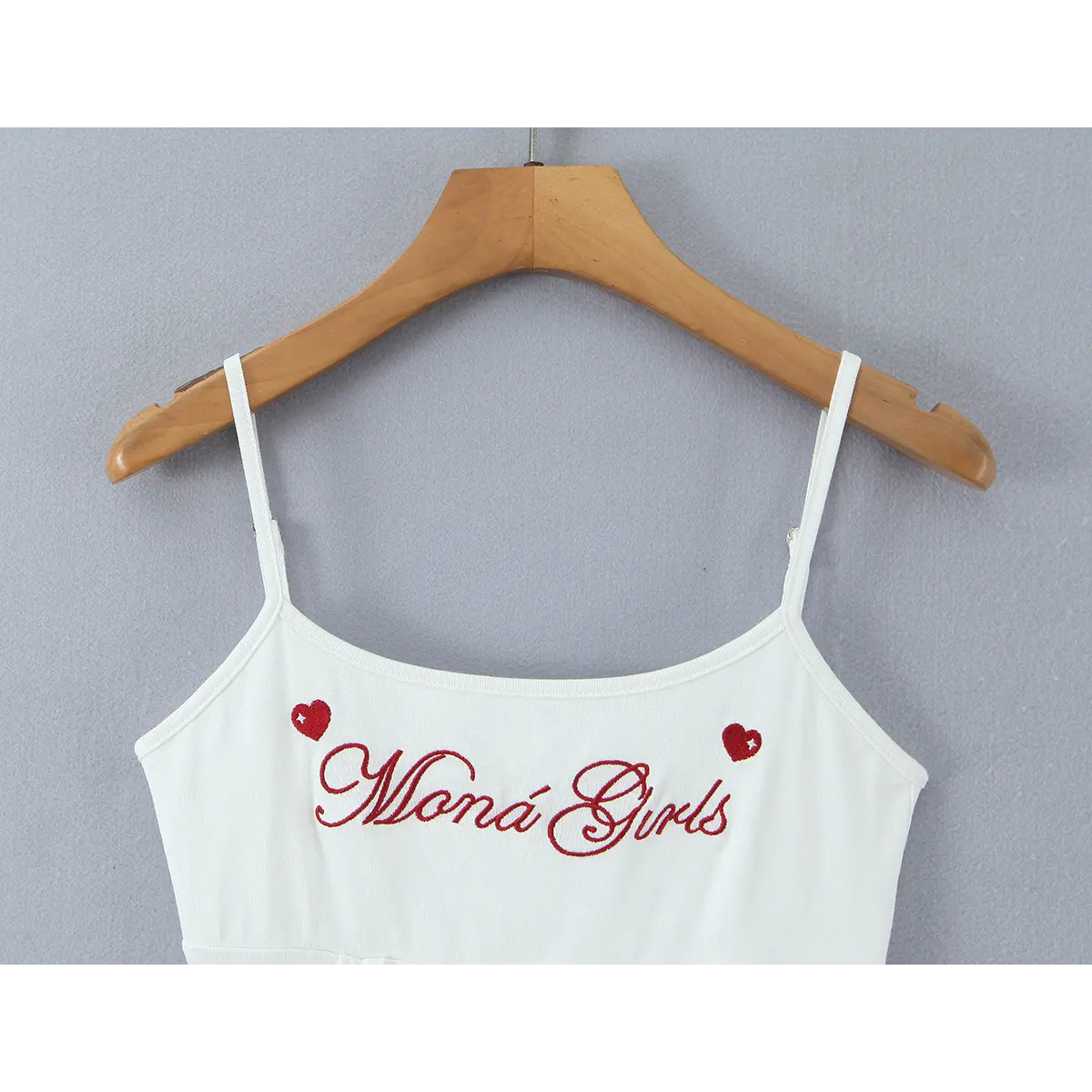  Close-up of the scoop neckline and thin spaghetti straps, showcasing the red embroidered text and hearts at the bust.