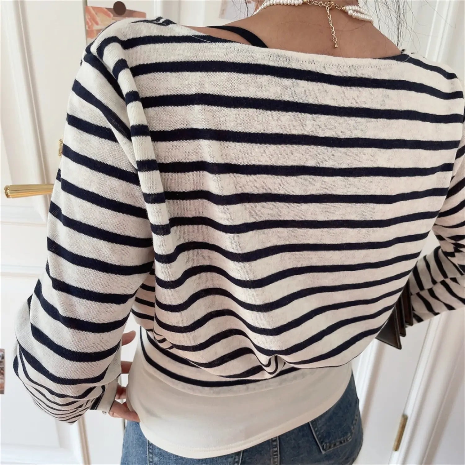 Model back view wearing white navy striped wrap cropped long sleeve top
