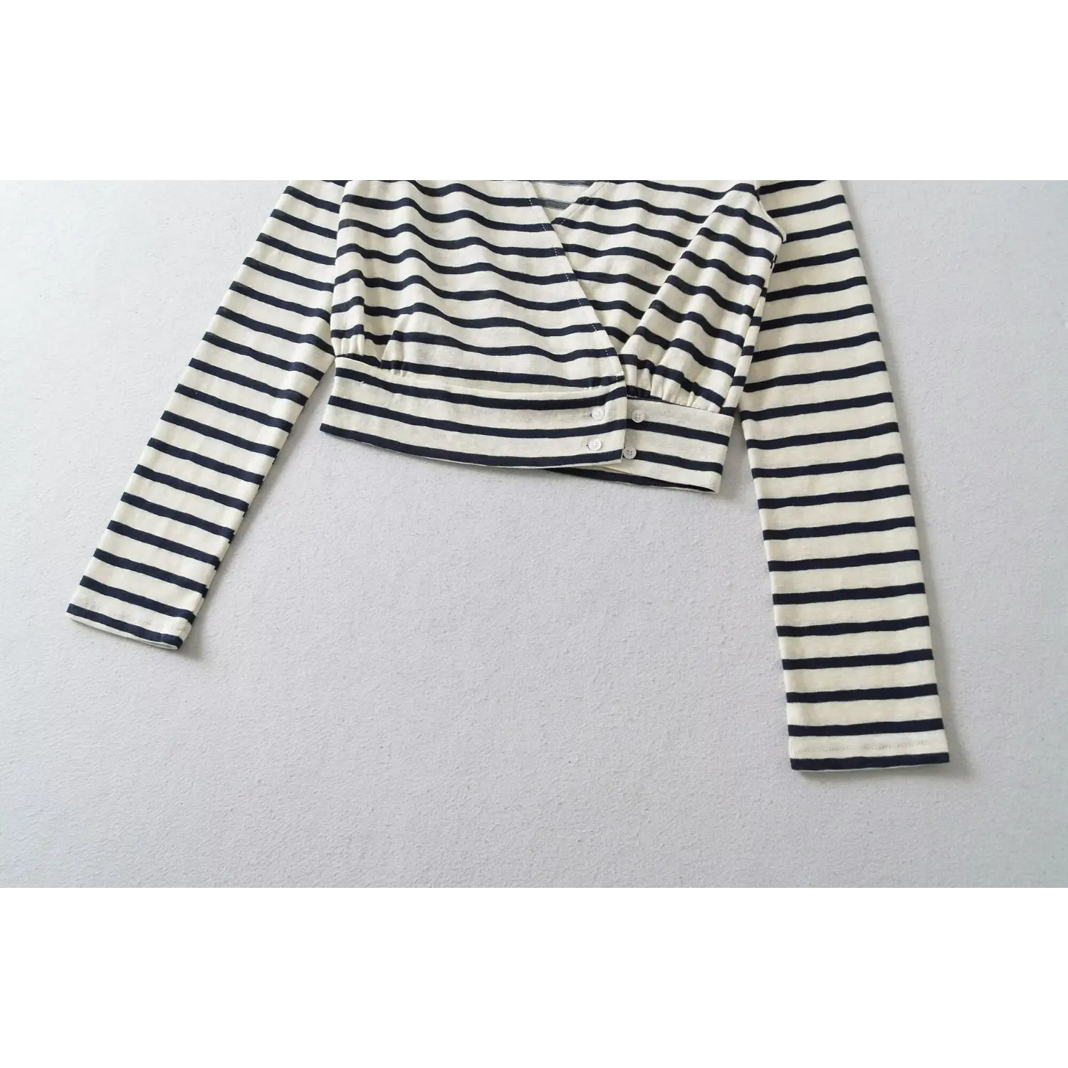 Flat lay front view white navy striped v-neck wrap long sleeve cropped top with side buttons