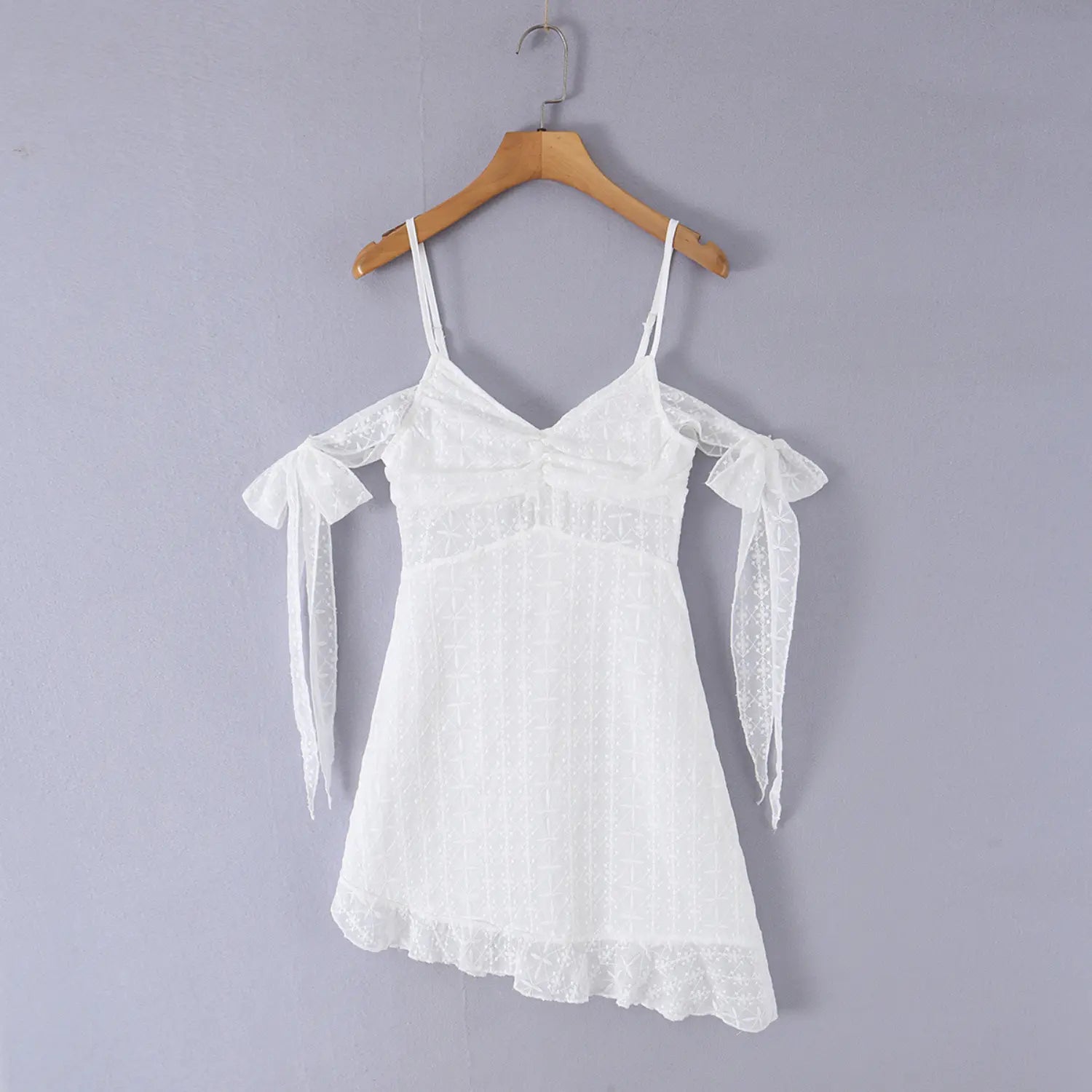 White off shoulder eyelet embroidered dress wooden hanger front display shot, full overview V shirred bust detachable arm tie bows irregular ruffle skirt fit shot