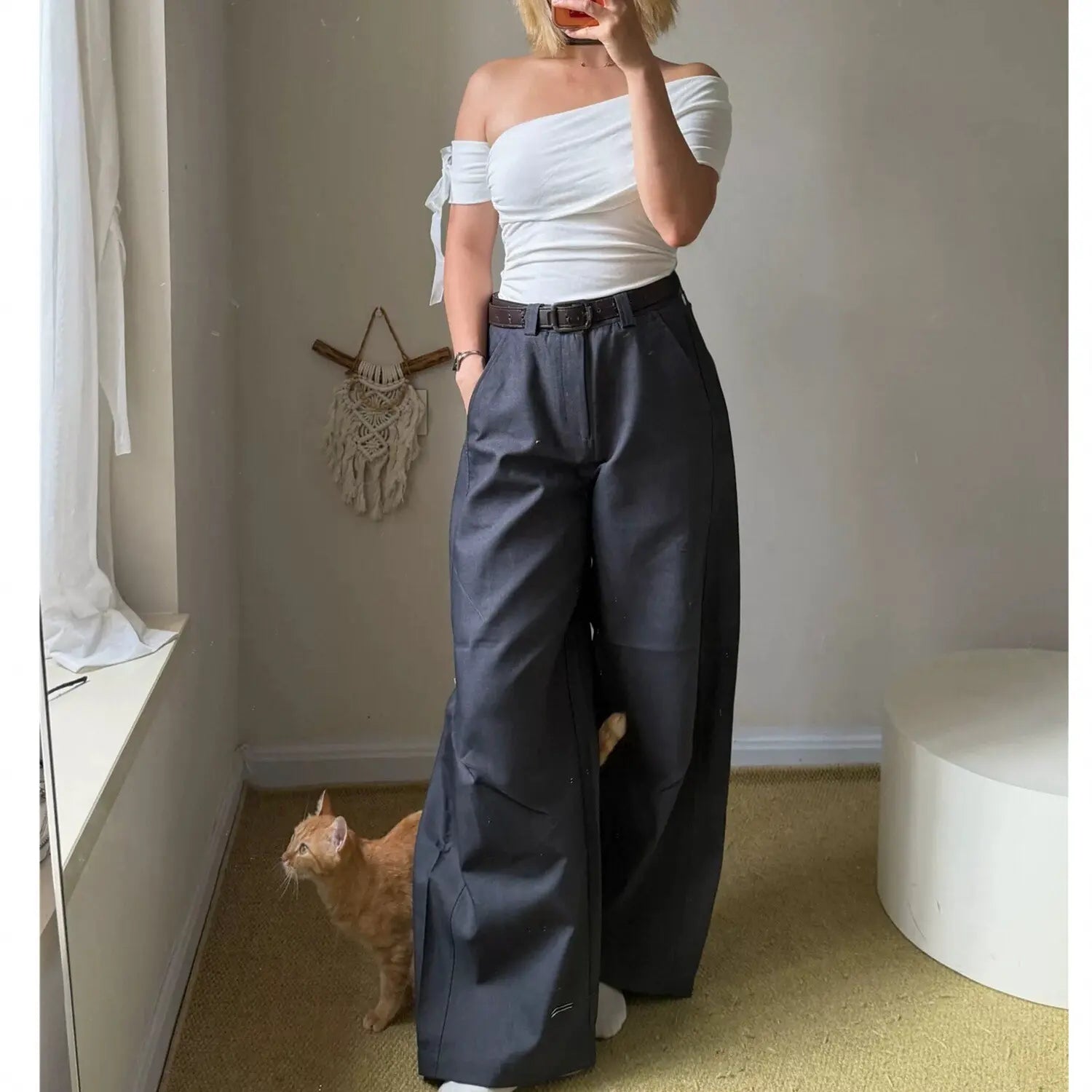 White off shoulder ruched top with bow sleeve paired with charcoal gray wide leg cargo pants, side view full body mirror selfie outfit shot