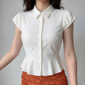 Model front view wearing white cap sleeve peplum waist collared shirt