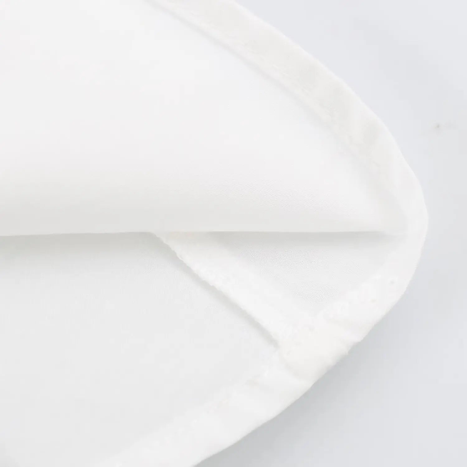 Close-up finished hem seam of white peplum waist blouse