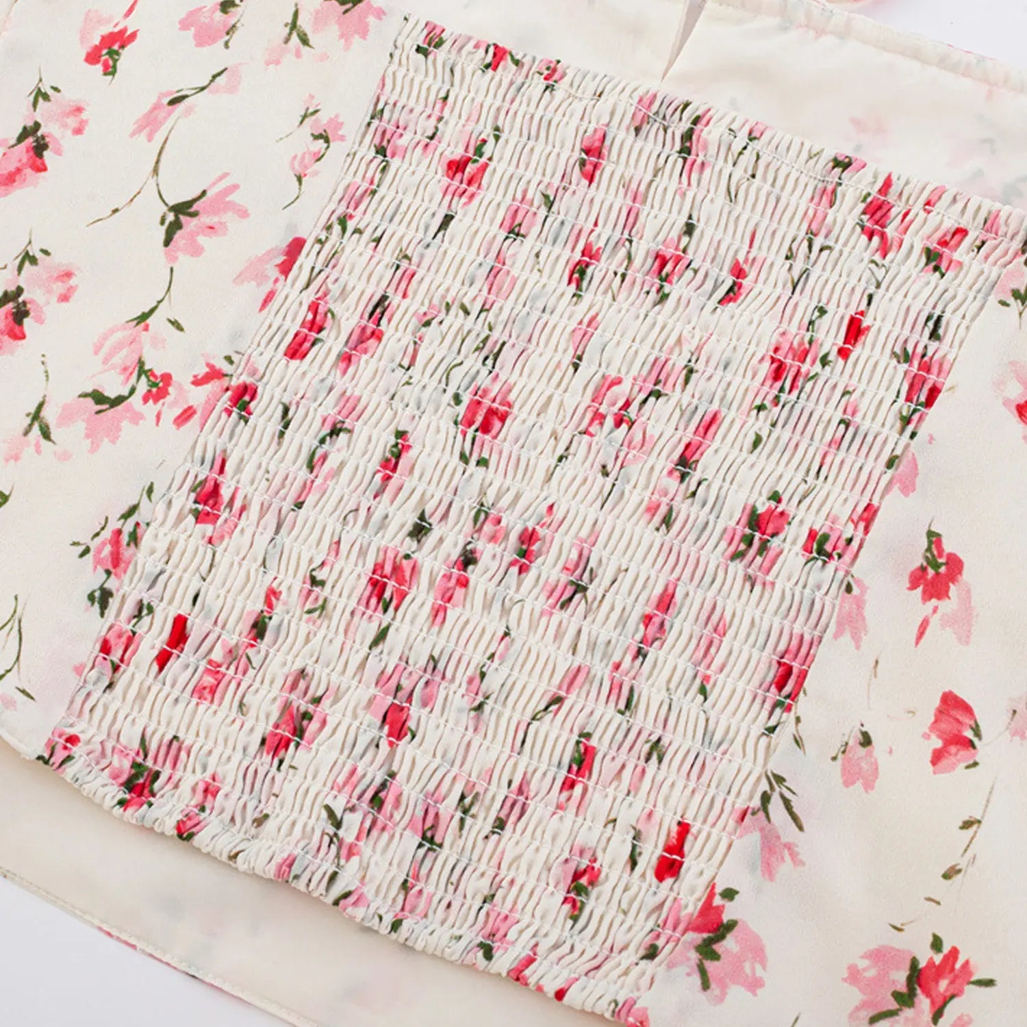 White pink watercolor floral cami waist flat close-up, full elastic smocked stitching flower printed chiffon woven fabric white background shot
