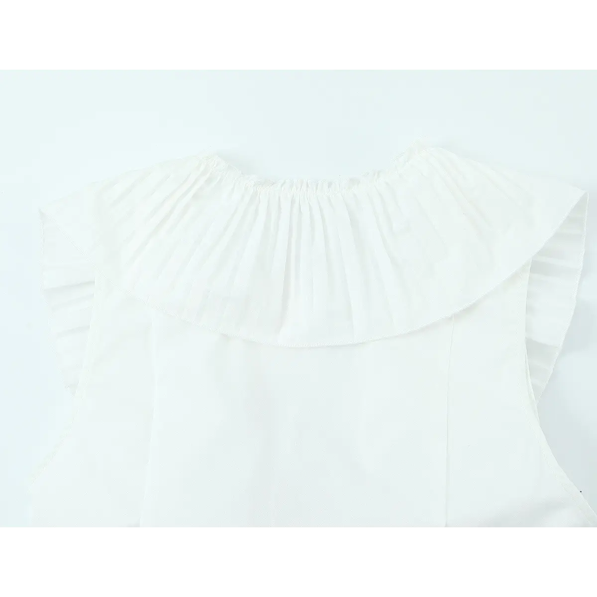 Back view of the white ruffle top, showing the wide pleated neckline, gathered trim, and wing sleeves