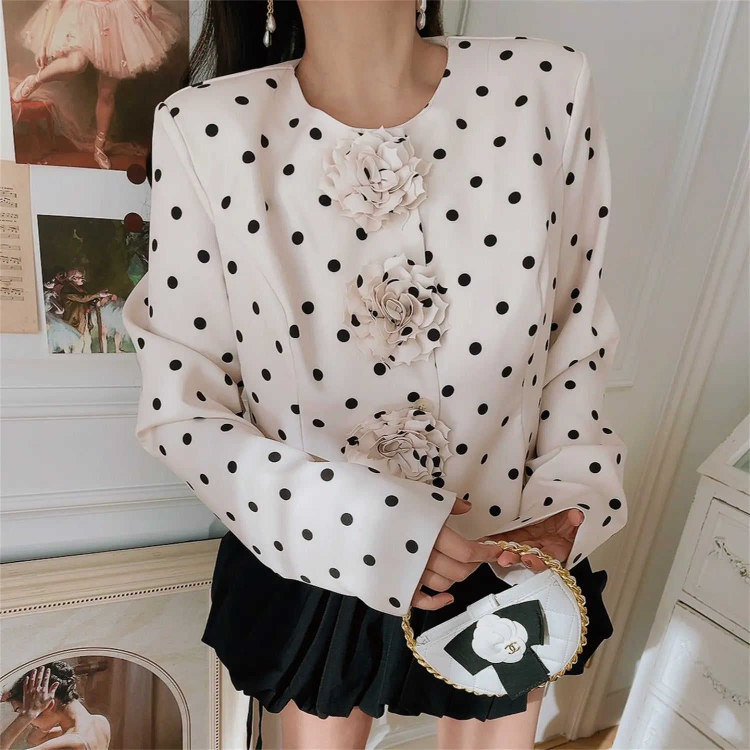 Medium shot outfit look, woman wearing white polka dot cropped jacket with 3D rose ornaments and black mini skirt